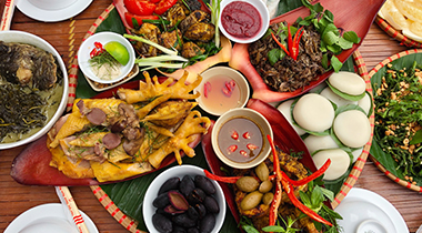Xuan Son duck grilled in bamboo — a forest feast served on a platter of leaves